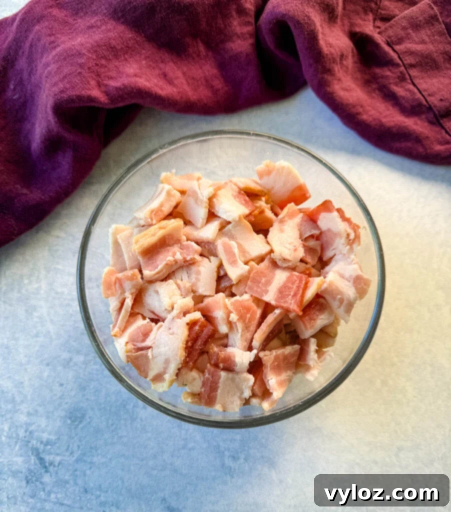diced pieces of raw bacon in a glass bowl