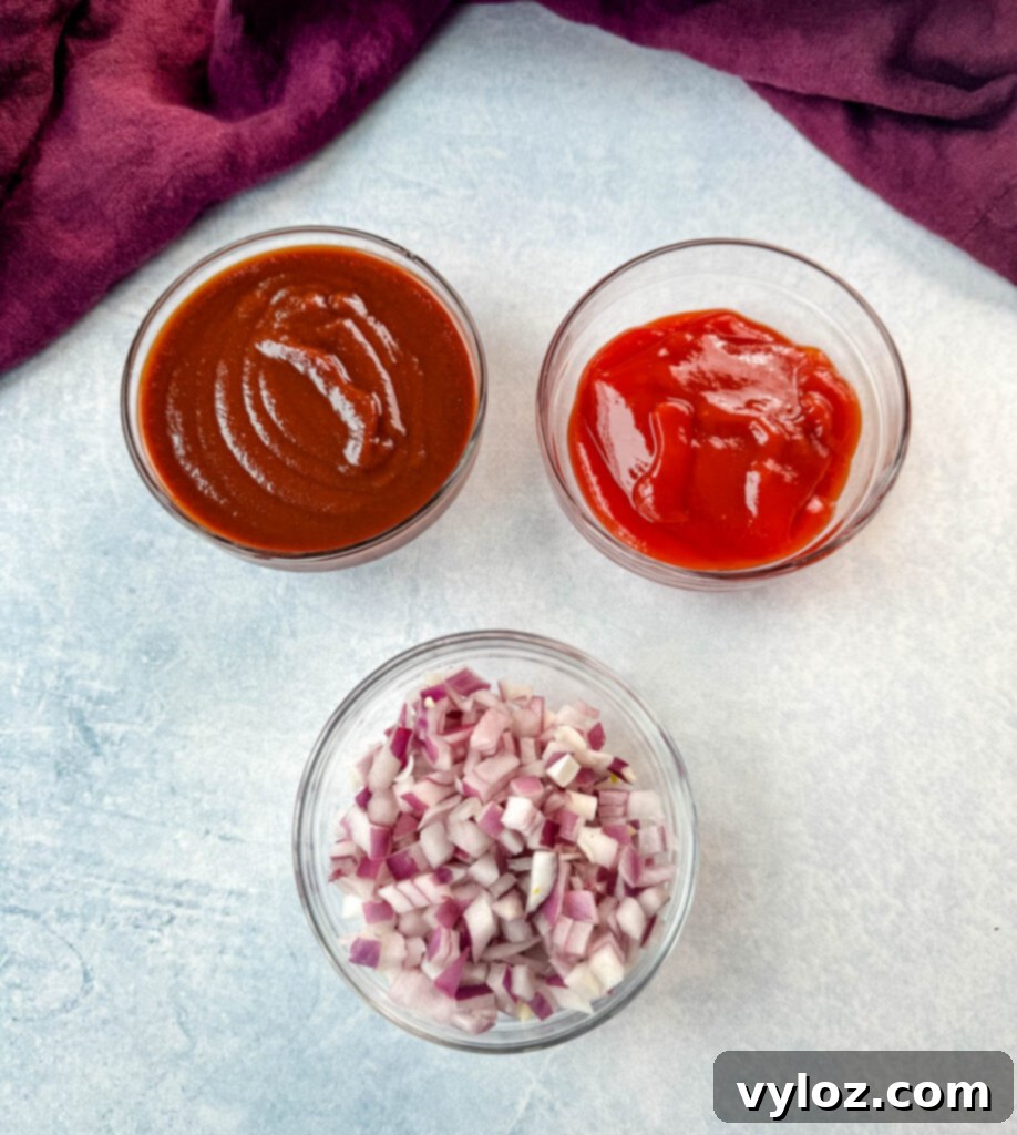 Smoky Slow Cooker Bacon Baked Beans 3 BBQ sauce, ketchup, and diced onions in a glass bowl