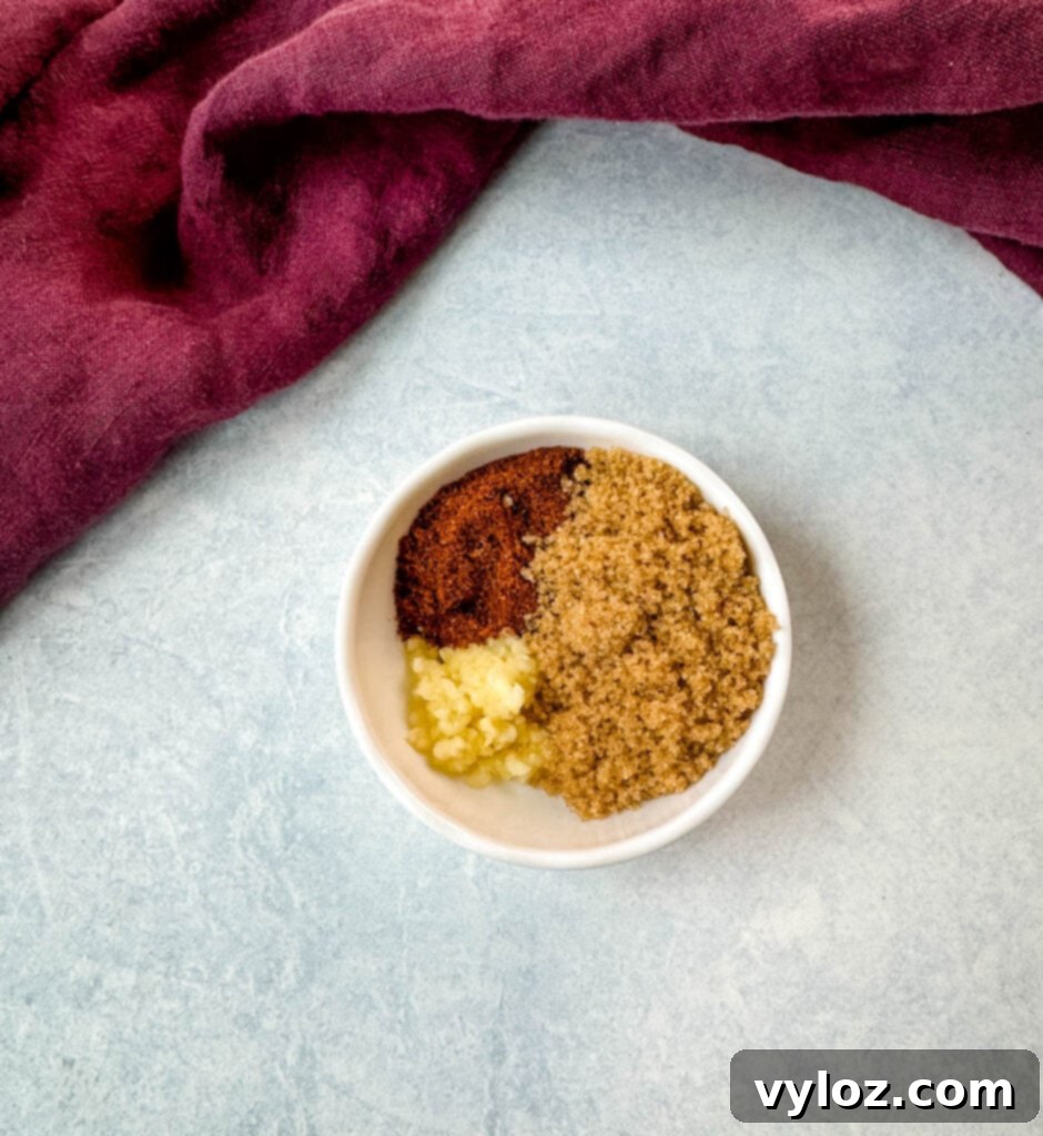 Smoky Slow Cooker Bacon Baked Beans 5 chili powder, brown sugar, and garlic in a white bowl