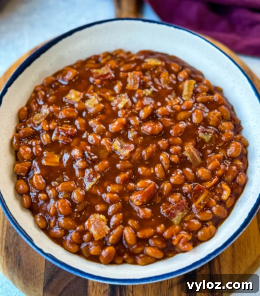 Smoky Slow Cooker Bacon Baked Beans 10 slow cooker Crockpot baked beans in a white bowl