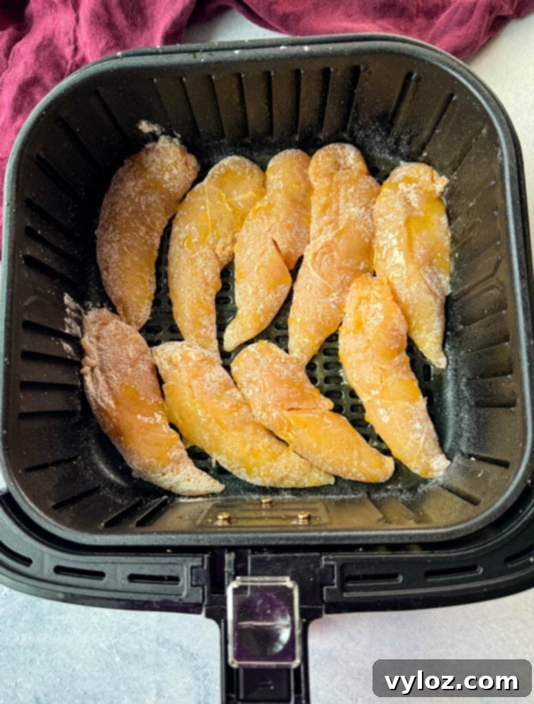 Sweet Heat Chicken Tenders 7 raw seasoned chicken tenders in an air fryer