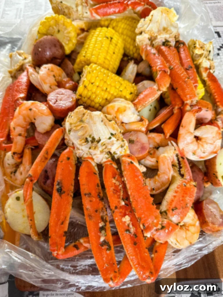 Garlic Butter Seafood Boil Bag 11 A beautifully arranged seafood boil in a bag with snow crab clusters, shrimp, potatoes, corn on the cob, and sausage.