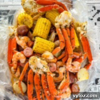 Garlic Butter Seafood Boil Bag 13 Seafood boil in a bag with snow crab clusters, shrimp, potatoes, corn on the cob, and sausage.