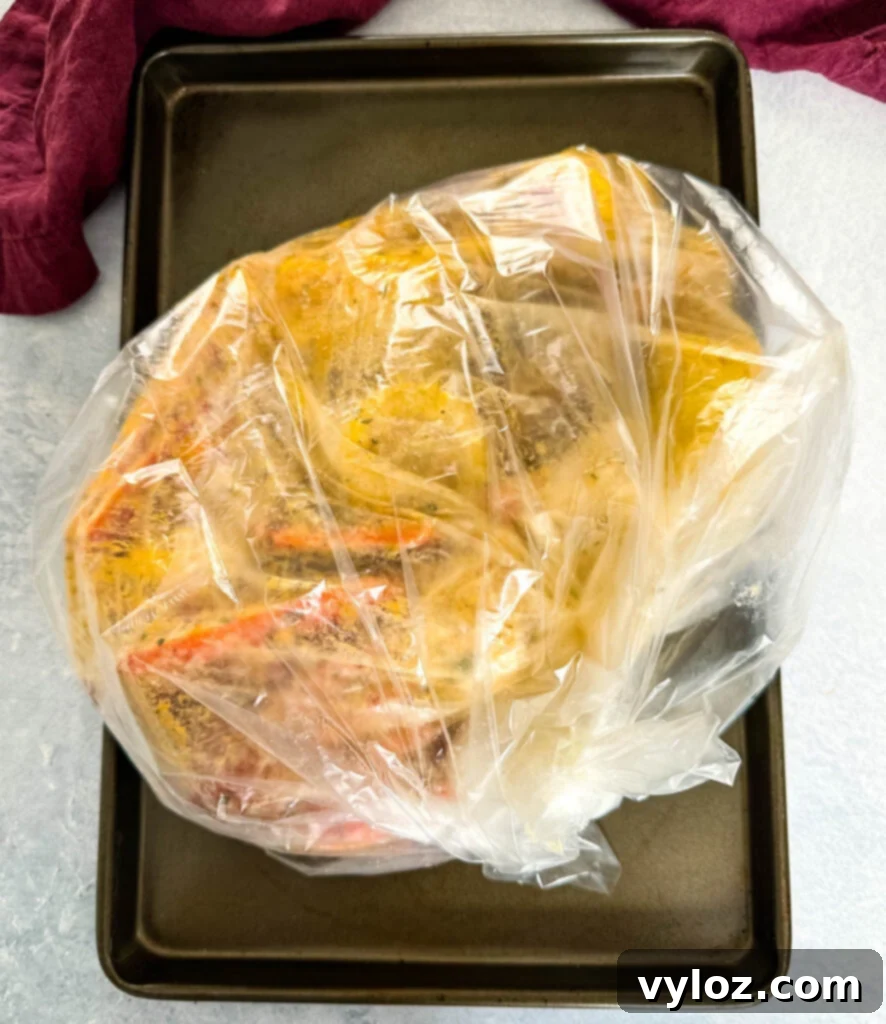 Garlic Butter Seafood Boil Bag 9 Seafood boil in a bag with snow crab clusters, shrimp, potatoes, corn on the cob, and sausage, ready for baking.