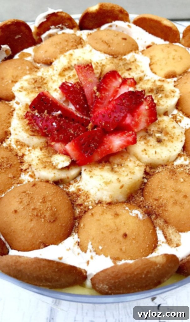 Close-up of the delightful layers of banana pudding trifle, showing soft wafers, creamy pudding, and fresh banana slices, ready to be scooped