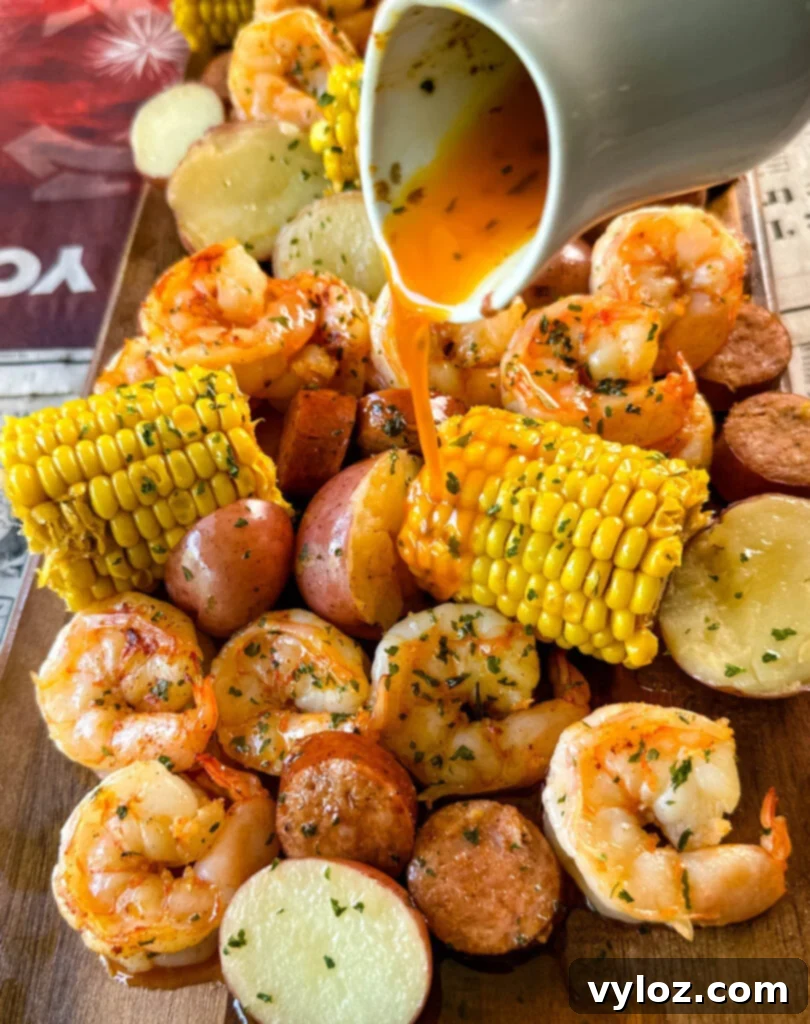 shrimp boil with andouille sausage, red potatoes, and corn on the cob drizzled with lemon butter sauce