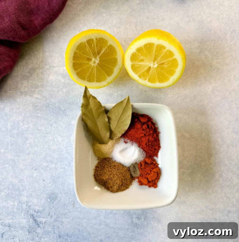 Cajun spices, bay leaves, and fresh lemon on a flat surface