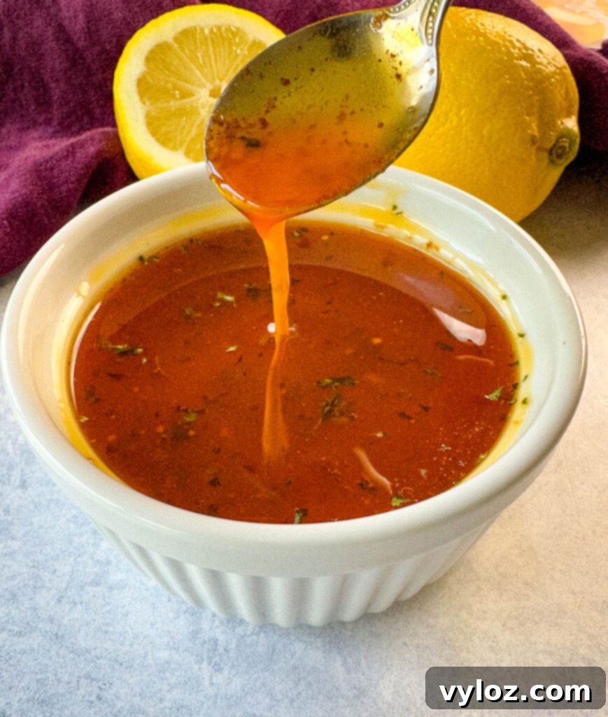 Cajun Crawfish Feast 12 A spoonful of rich crawfish boil sauce with melted butter and lemon over a white bowl