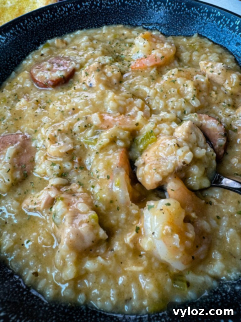 Cajun jambalaya soup in a black bowl