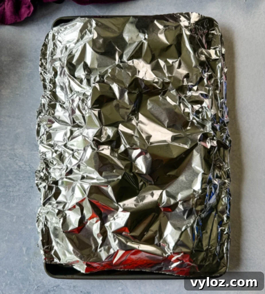 Sweet Dungeness Crab Legs 7 Dungeness crab legs on a sheet pan covered with foil