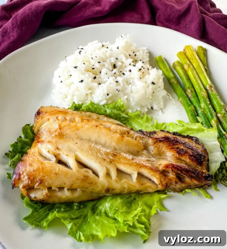 Mastering Nobu's Miso Black Cod 2 Nobu miso black cod on a plate with white rice and asparagus