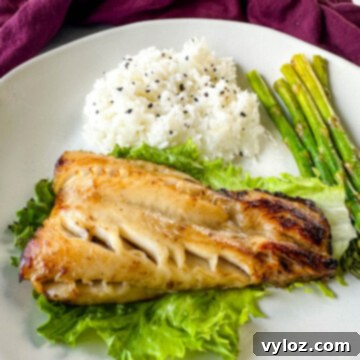 Mastering Nobu's Miso Black Cod 13 Nobu miso black cod on a plate with white rice and asparagus