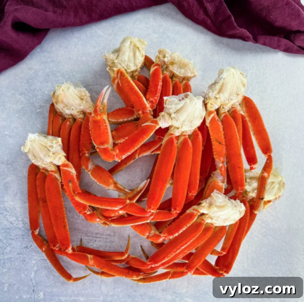 Close-up of raw snow crab legs on a flat surface, ready for preparation