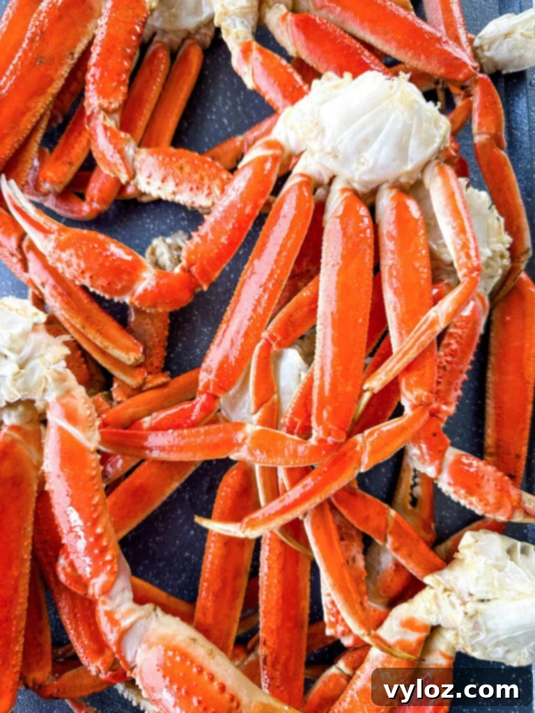 Smoked crab legs arranged on a sheet pan, ready to be served with smoky garlic butter