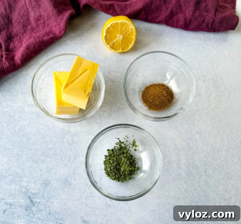 Ingredients for smoky garlic butter: melted butter, lemon, Old Bay, smoked paprika, and parsley in small glass bowls