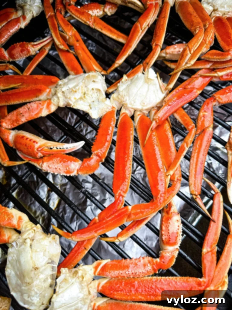 More smoked crab legs on a Traeger grill, showing the delicious crust forming