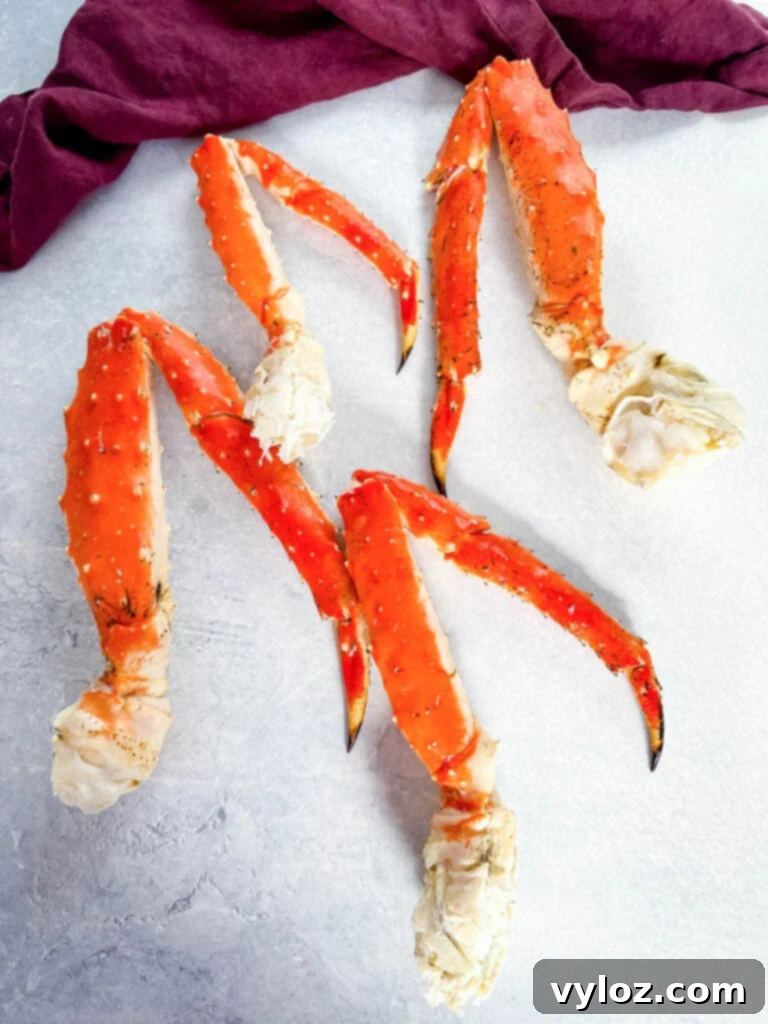 Fresh king crab legs displayed on a flat surface, showcasing their size and texture.