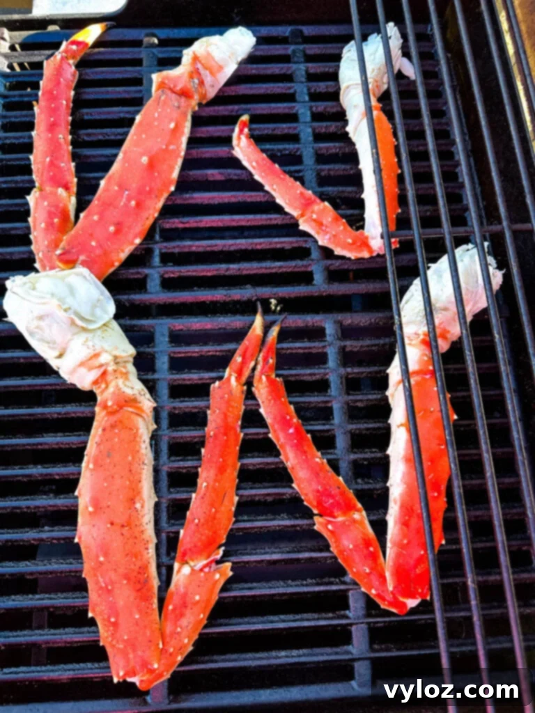 King crab legs arranged on a hot grill, showing the charring process