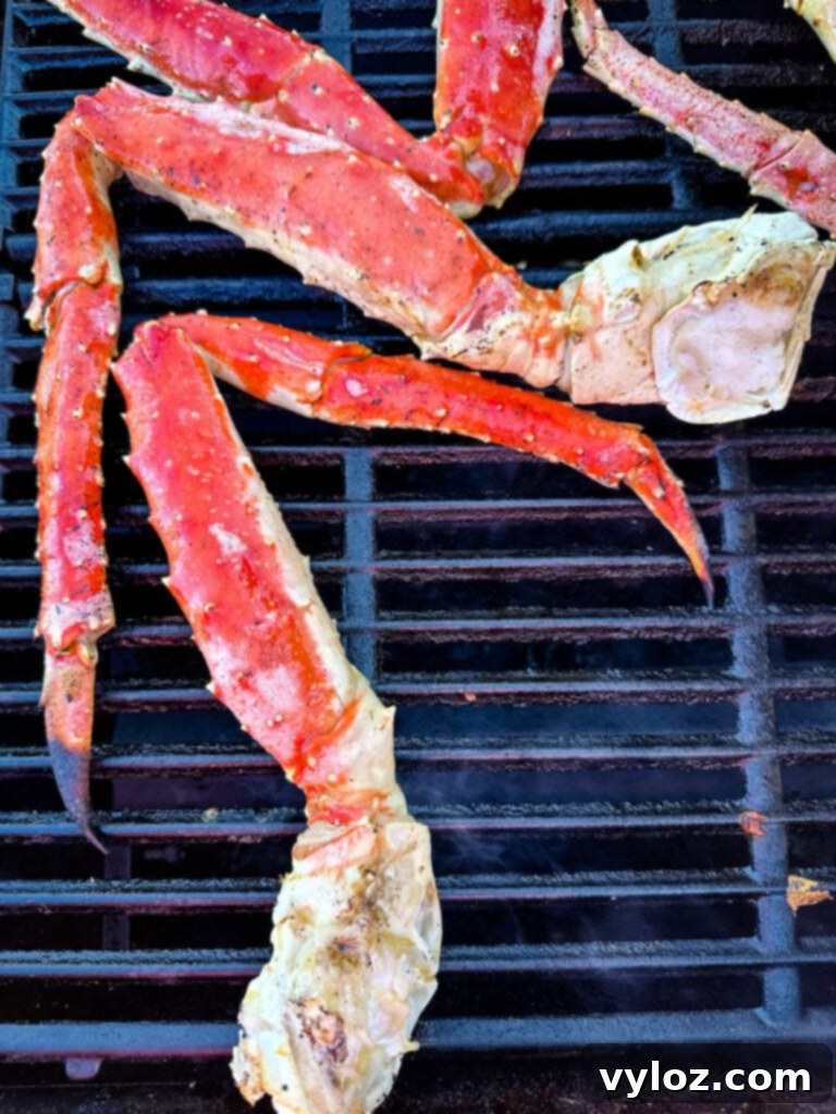 Grilled king crab legs arranged on a grill