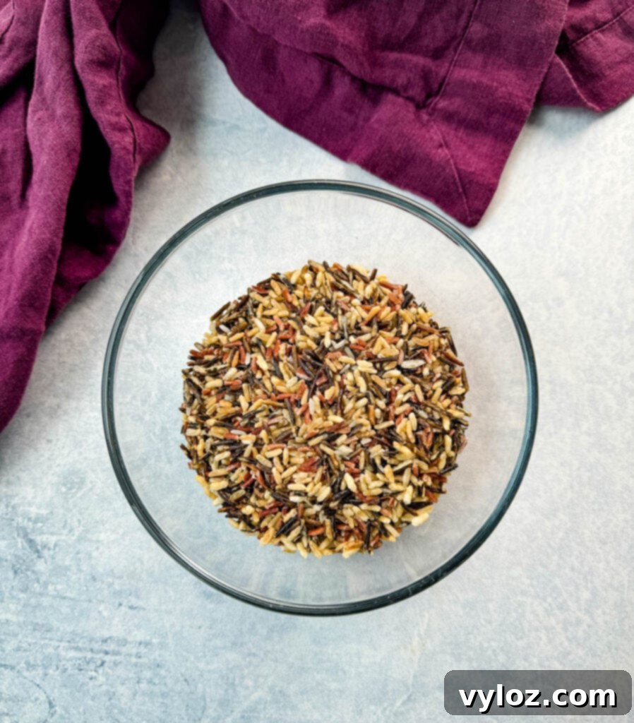 Velvety Chicken Wild Rice Soup 4 Wild rice in a glass bowl, showcasing its distinct, dark grains