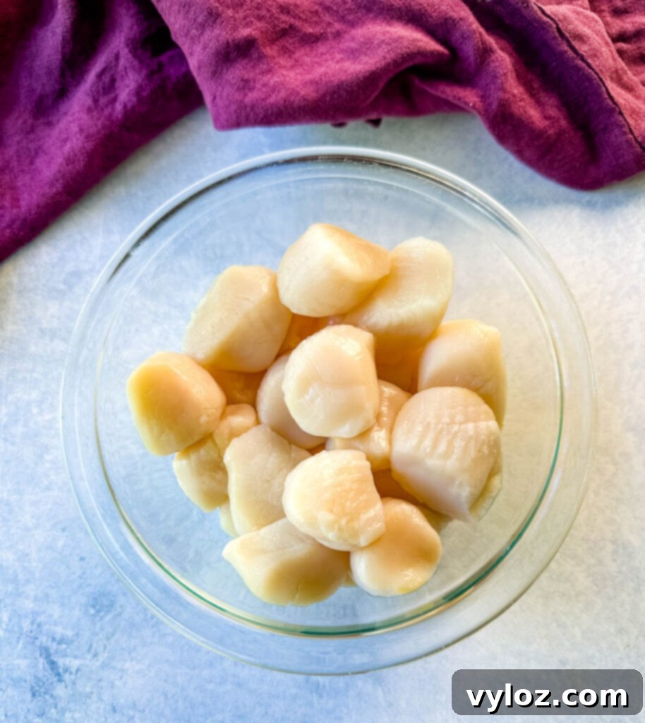 Chargrilled Citrus Scallops 4 raw scallops in a glass bowl