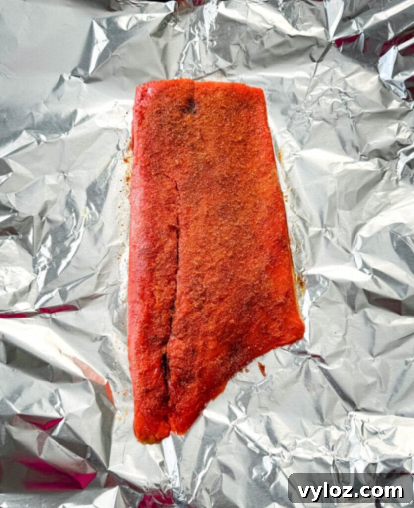 raw seasoned salmon on foil