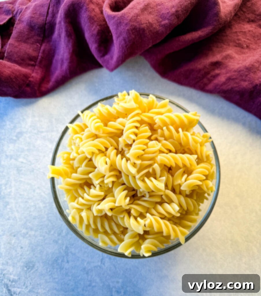 cooked rotini pasta in a glass bowl