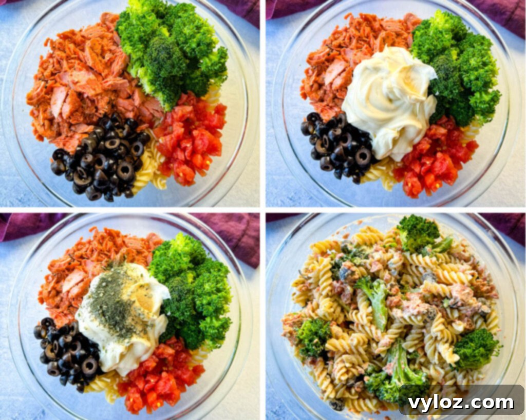 salmon pasta salad with broccoli, mayo, ranch seasoning, and tomatoes in a glass bowl