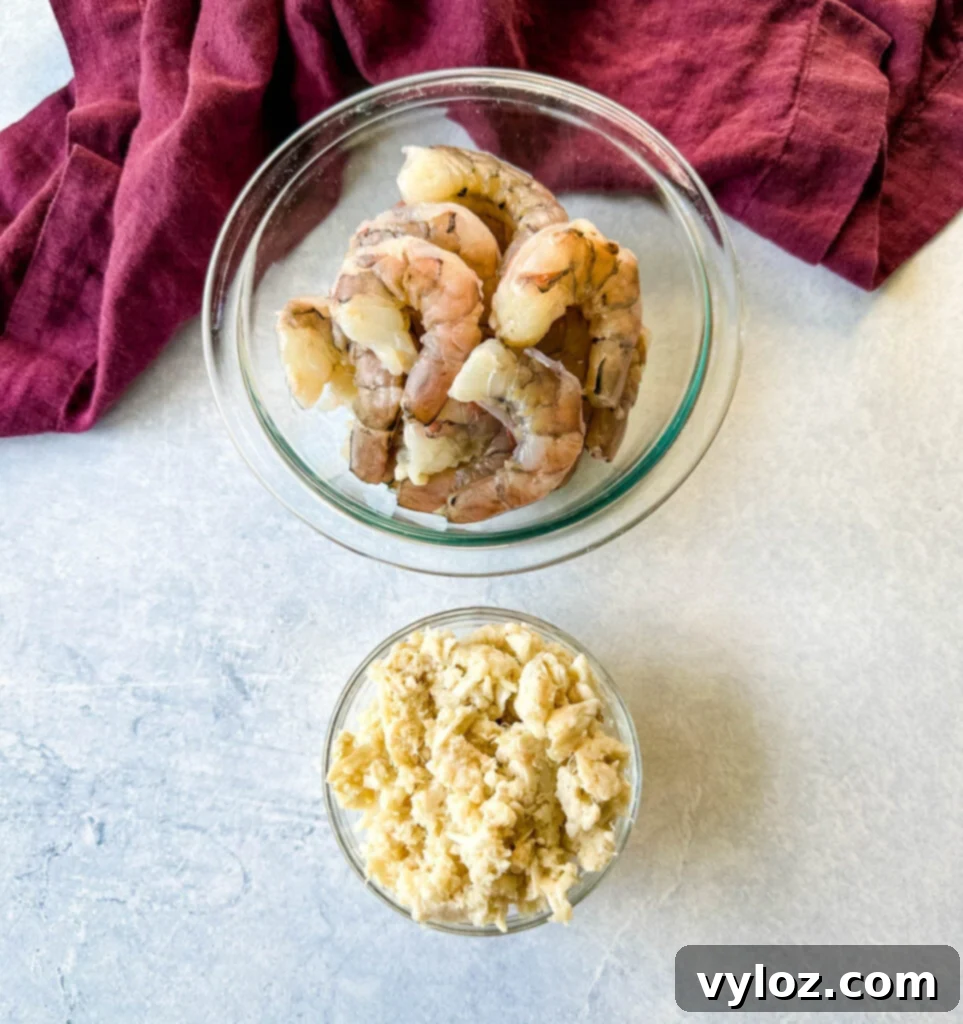 raw shrimp peeled and deveined and lump crab in separate glass bowls