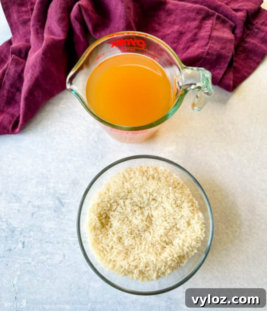 chicken broth and white rice in separate glass bowls