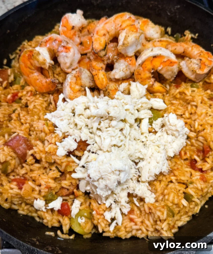 Creole shrimp jambalaya with crab in a cast iron skillet