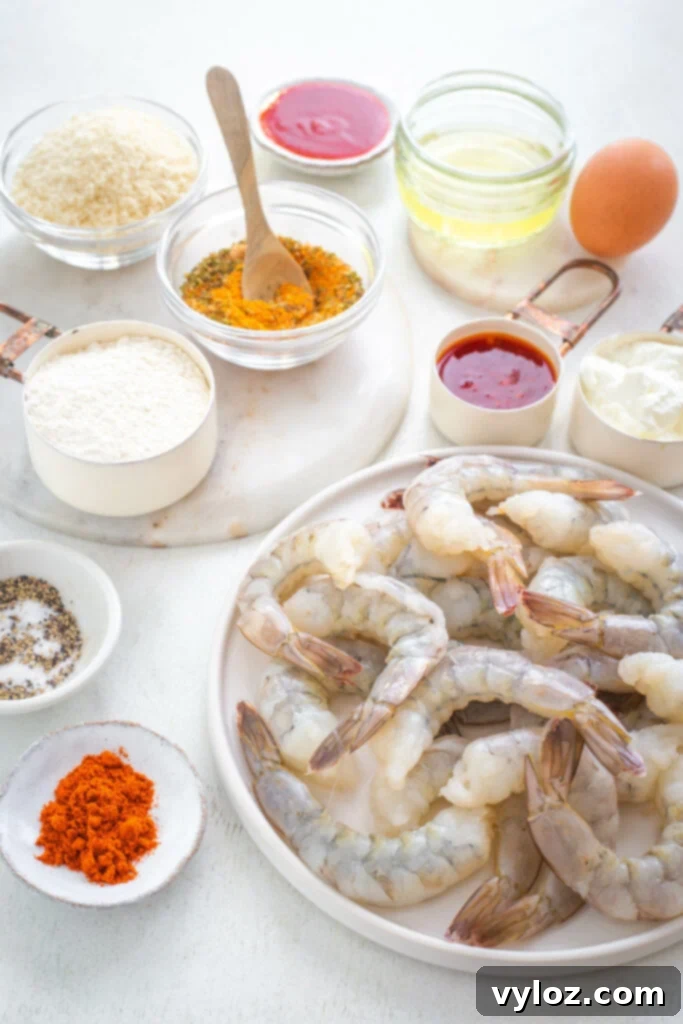 Raw shrimp and breading ingredients in separate bowls for air frying