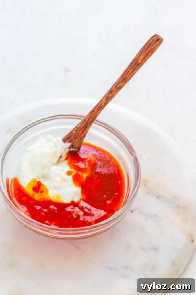 Mixed ingredients for homemade bang bang sauce in a bowl