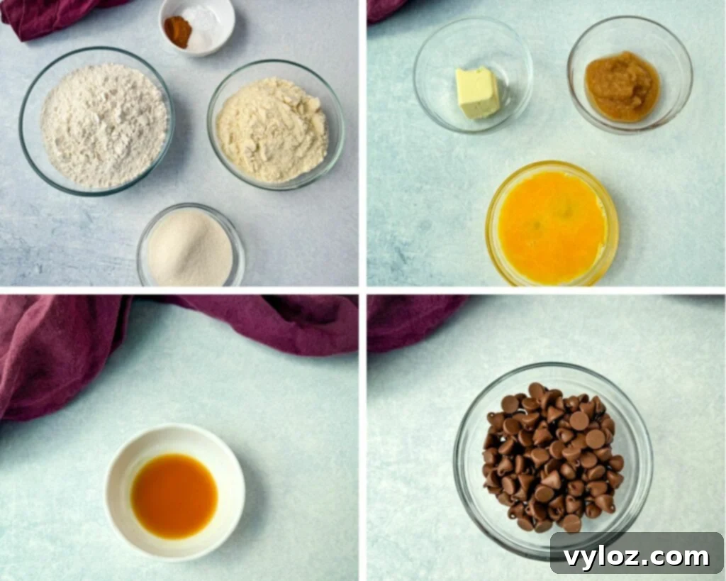 A collection of key ingredients for pumpkin protein muffins, including protein powder, pumpkin pie spice, flour, applesauce, eggs, vanilla extract, chocolate chips, and melted butter, arranged in separate glass bowls on a white background.