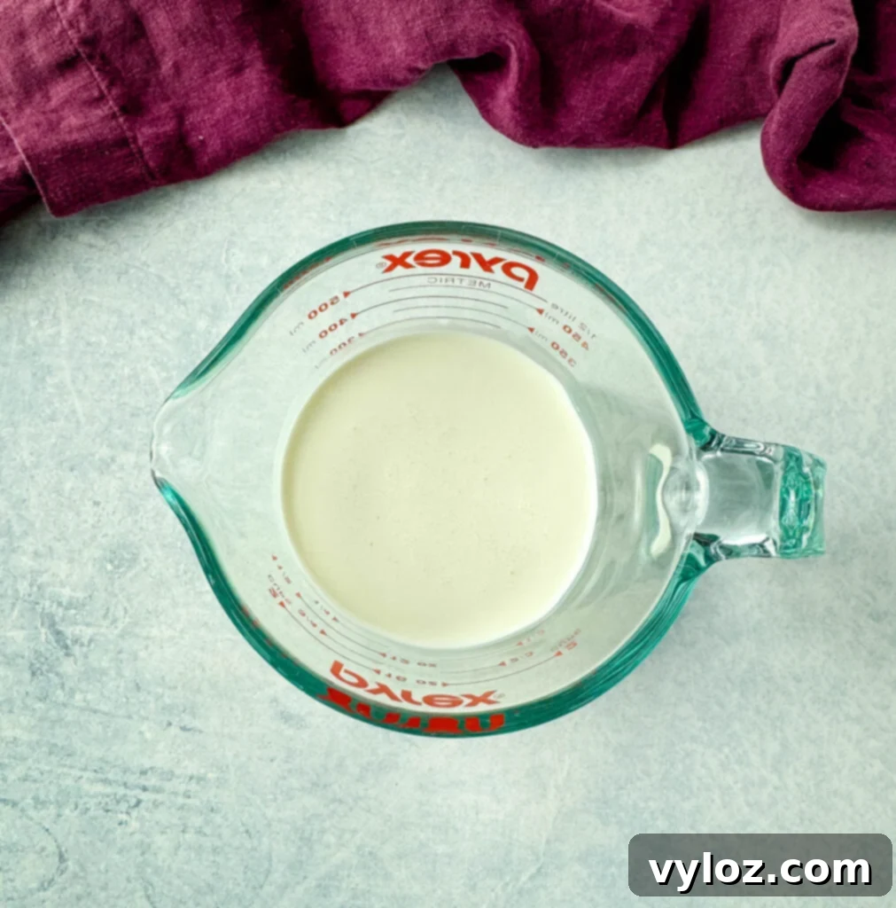 Gourmet Grilled Cheese & Tomato Soup Pairings 4 Heavy whipping cream in a glass measuring cup, ready to be added to the soup.