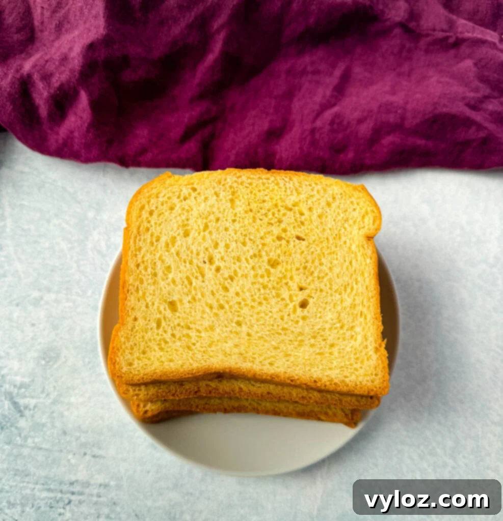 Gourmet Grilled Cheese & Tomato Soup Pairings 5 Sliced brioche bread on a plate, ideal for making a delicious grilled cheese.