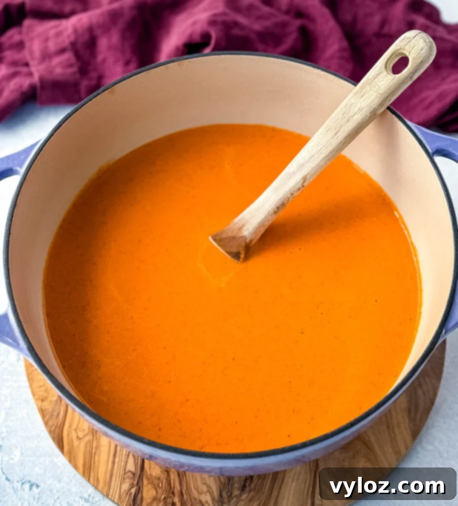 Gourmet Grilled Cheese & Tomato Soup Pairings 9 Creamy tomato soup simmering in a Dutch oven, rich and flavorful.