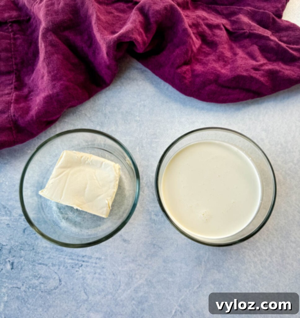 Creamy White Lasagna Soup 4 Glass bowls containing heavy whipping cream and cream cheese, key ingredients for a rich, creamy soup.