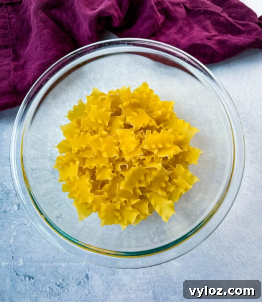 Creamy White Lasagna Soup 7 Wide ribbon pasta, similar to mini lasagna noodles, in a glass bowl.