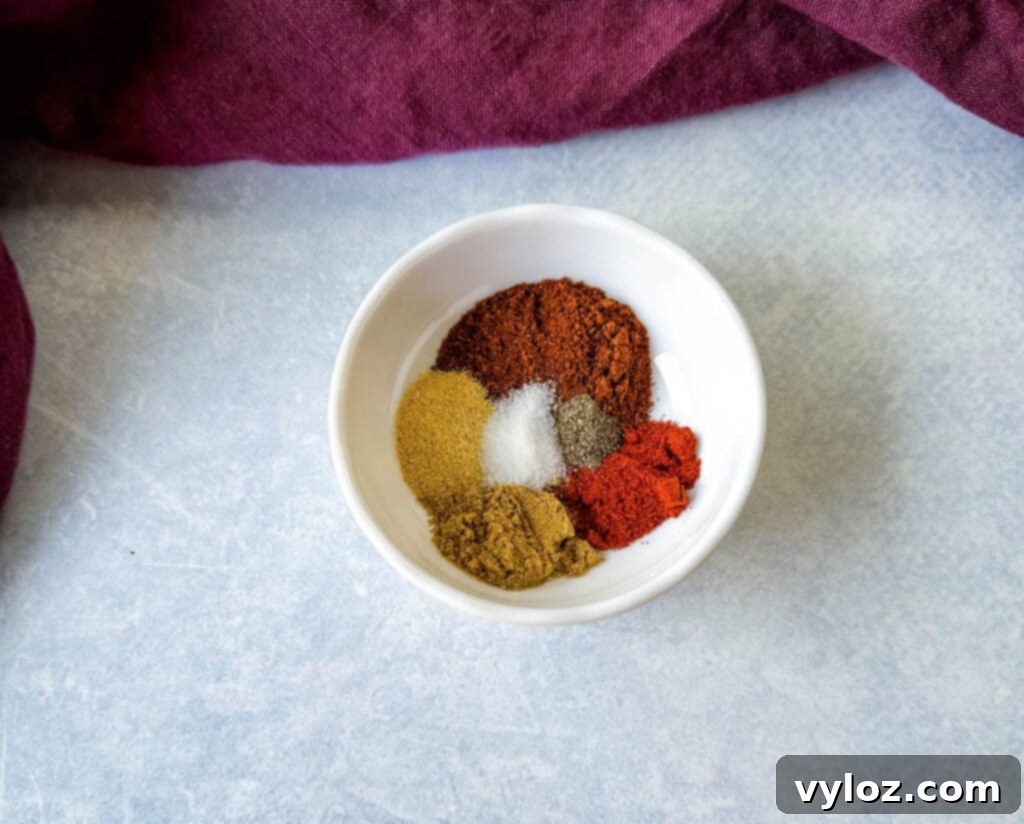 Zesty Shrimp Taco Bowl 6 A rich, reddish-brown homemade taco seasoning blend presented in a pristine white bowl, ready to infuse flavor into any dish.