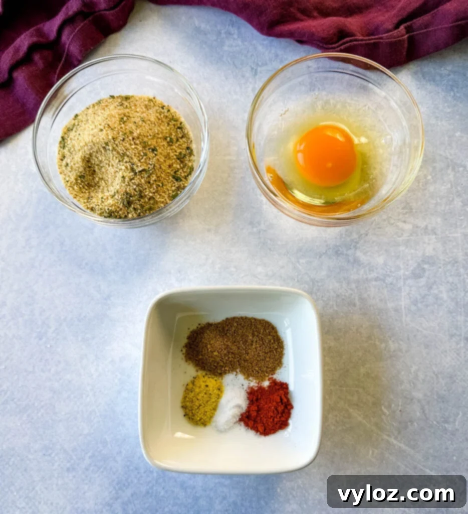 breadcrumbs, raw eggs, and spices in separate glass bowls