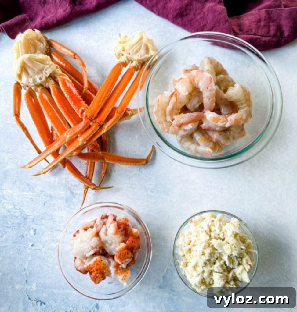 Assortment of fresh seafood: snow crab legs, raw peeled shrimp, lobster meat, and rich lump crab meat, meticulously arranged in separate glass bowls for a luxurious gumbo.