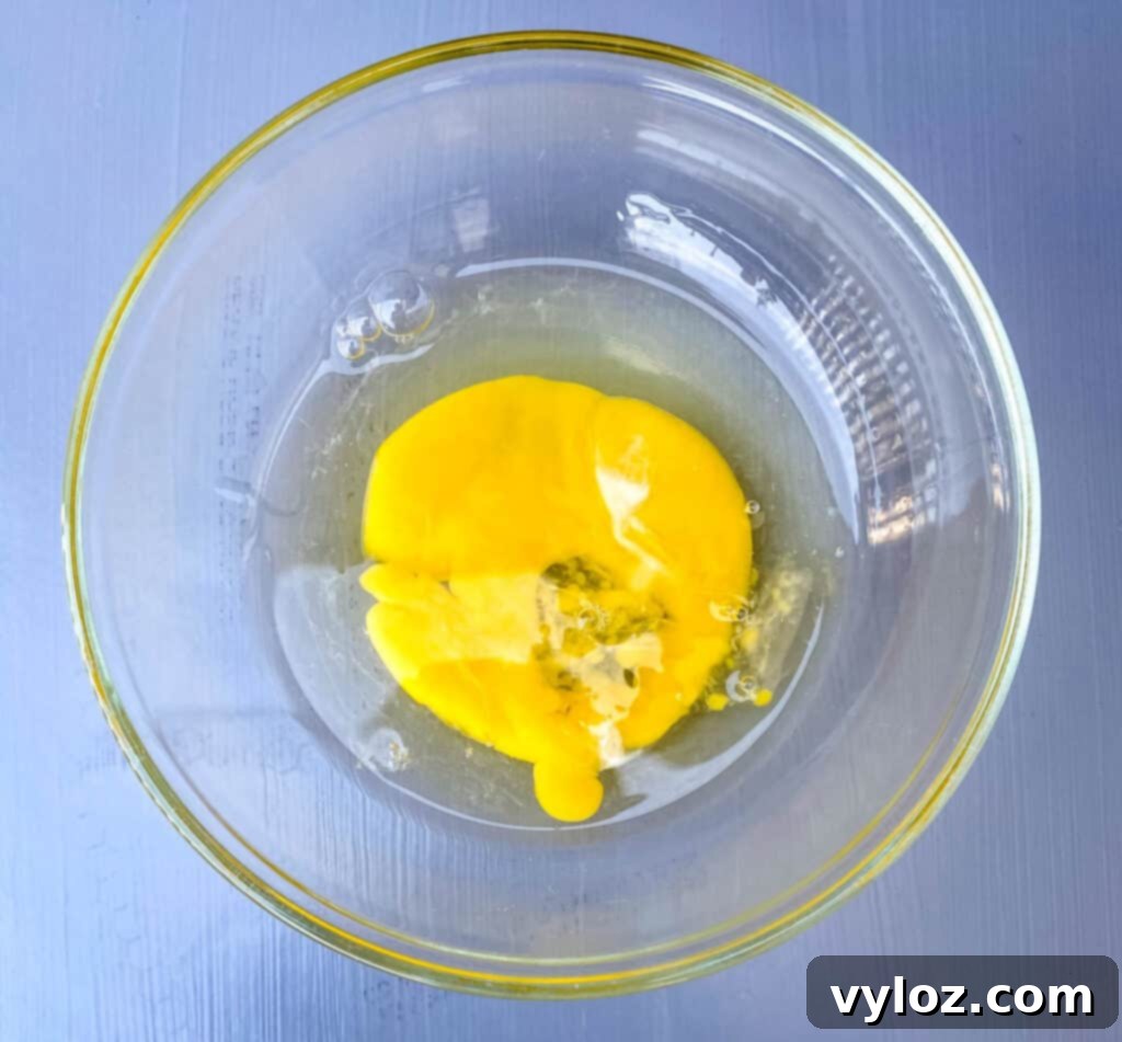 Golden Air Fryer Dessert Empanadas 4 a beaten egg in a glass bowl