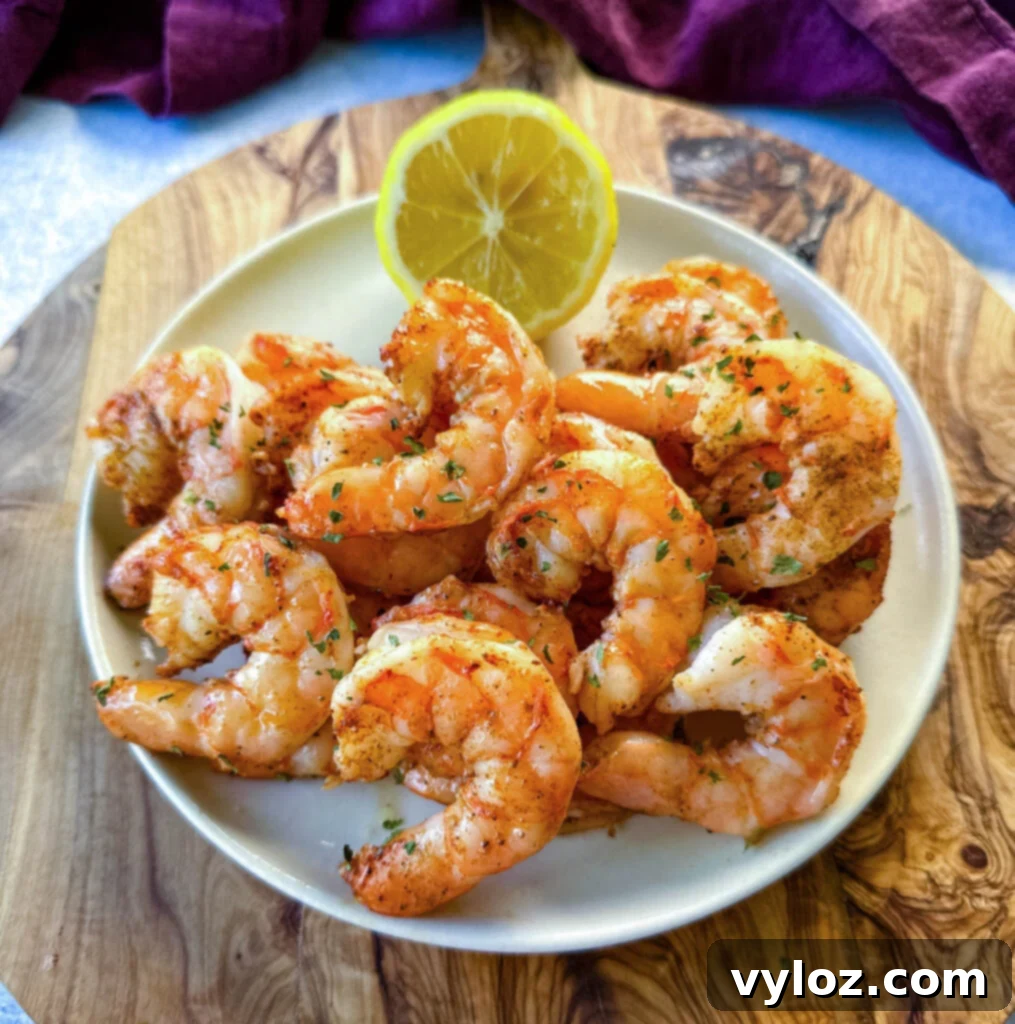 steamed and seasoned shrimp on a plate with fresh lemon
