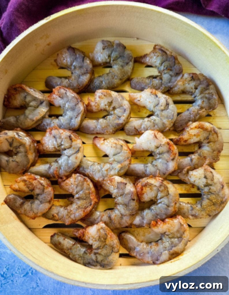 uncooked shrimp in a steaming basket