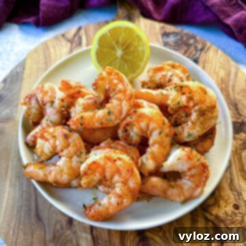 steamed and seasoned shrimp on a plate with fresh lemon