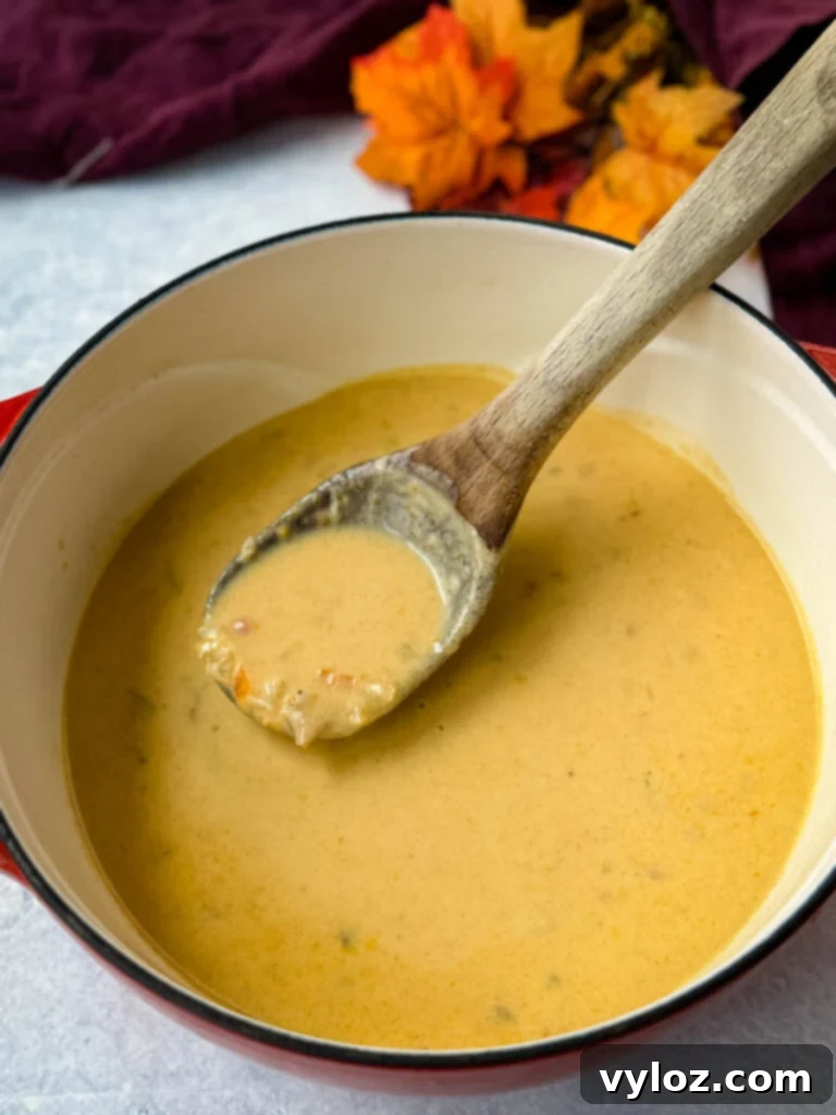 Creamy Beer Cheese Soup with Smoked Bacon 7 beer cheese soup with bacon in a red Dutch oven