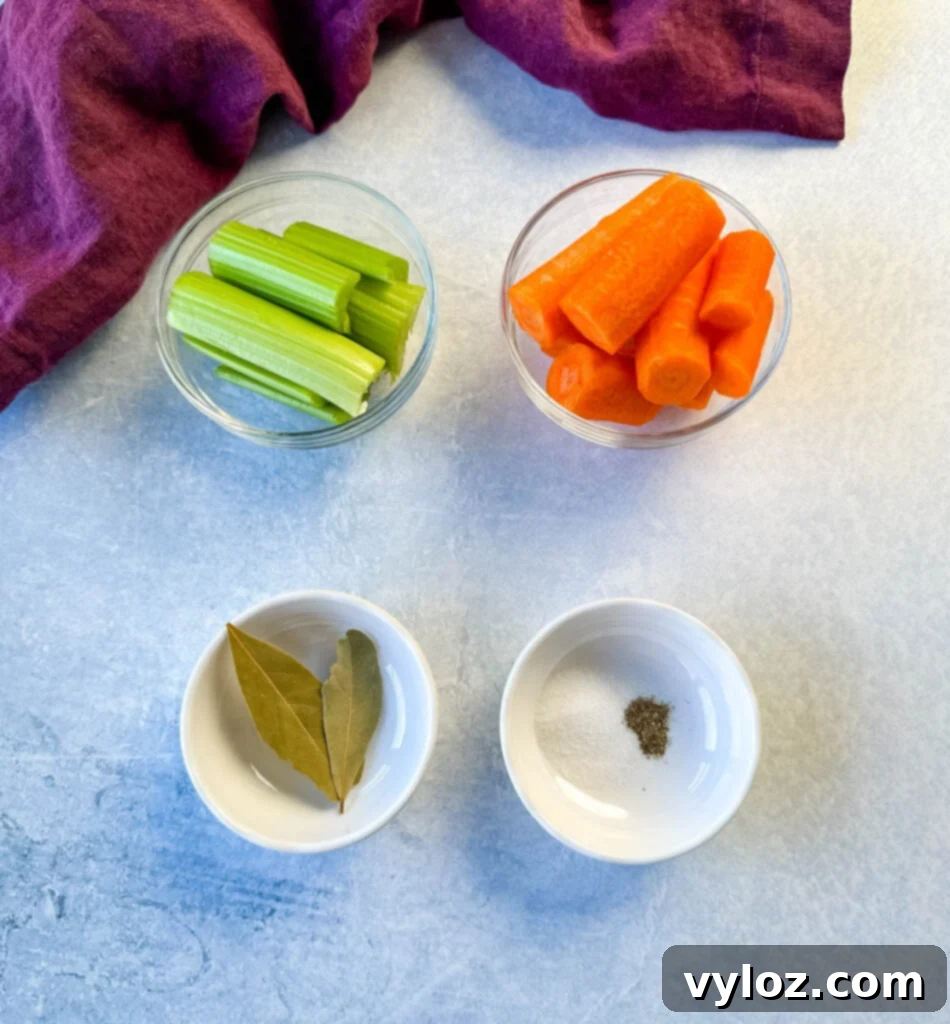 Oceanic Flavor Base 3 Celery stalks, whole carrots, bay leaves, and small bowls of salt and pepper on a rustic wooden surface, ready for stock preparation.