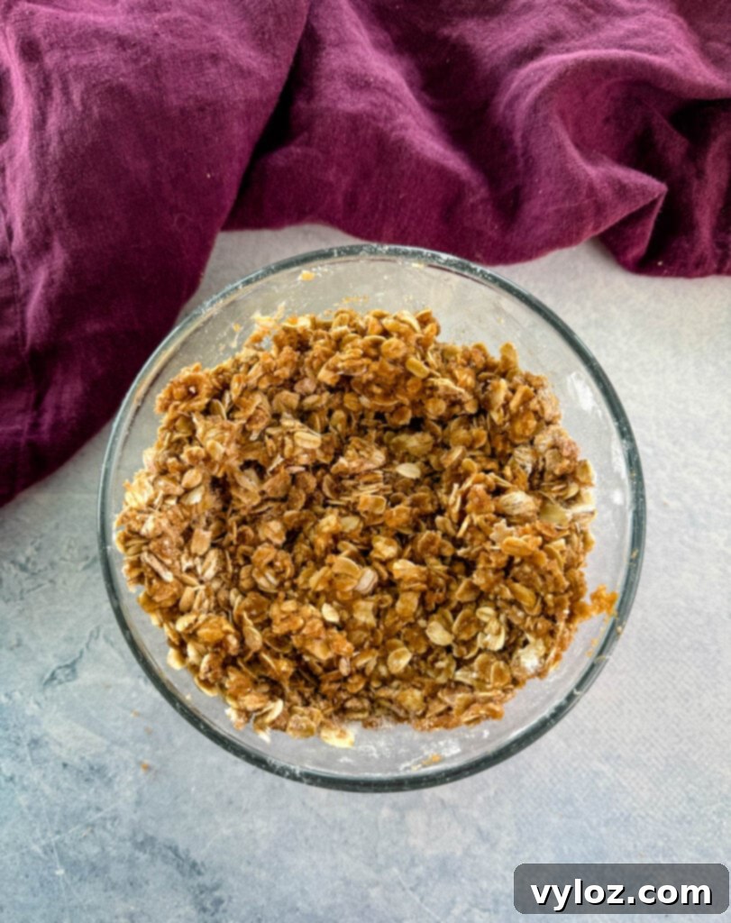 Effortless Crockpot Apple Crumble 6 apple crisp oat topping in a glass bowl