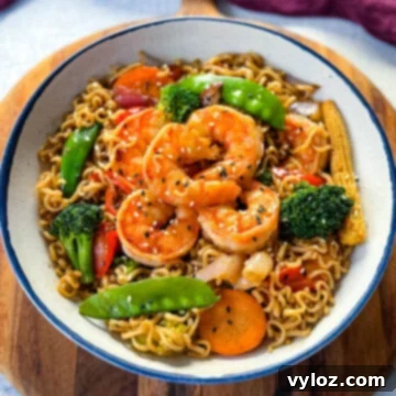 shrimp stir fry with noodles, vegetables, and a homemade sauce in a white bowl